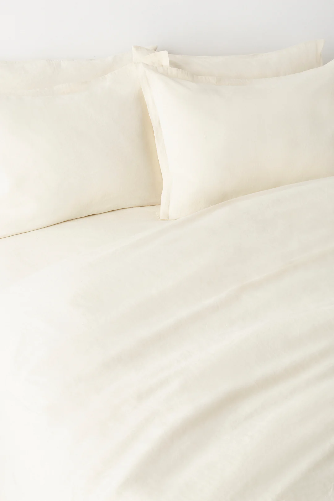Close-up of natural linen duvet cover texture showing quality weave